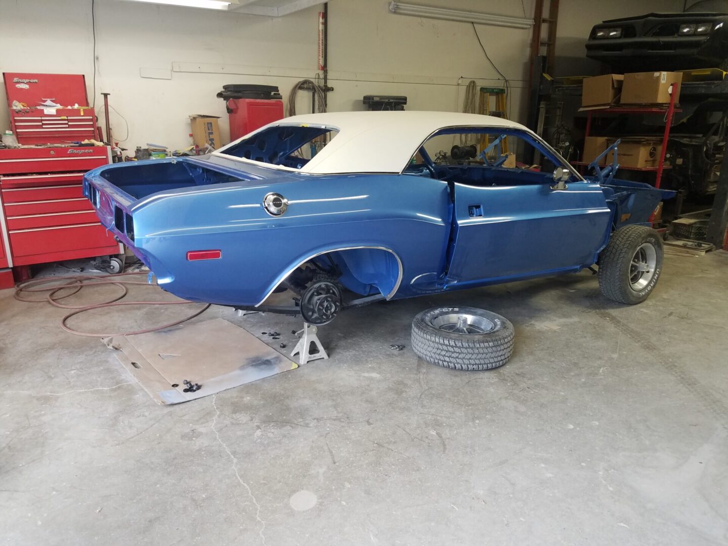 A blue 1972 Dodge Challenger Rallye without back wheels