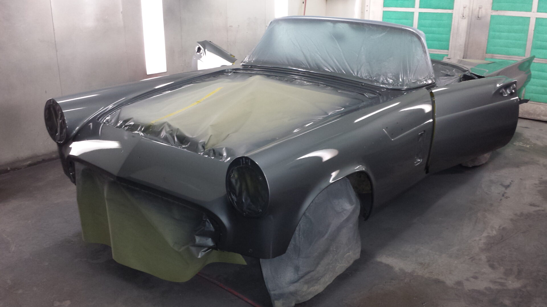 A 1957 Ford Thunderbird with dark grey paint