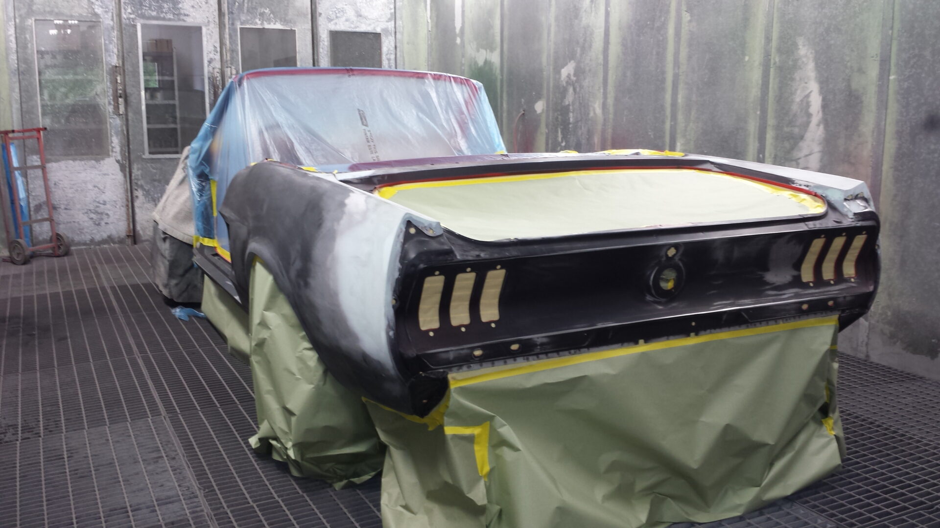 A 1967 Ford Mustang Convertible covered in wraps
