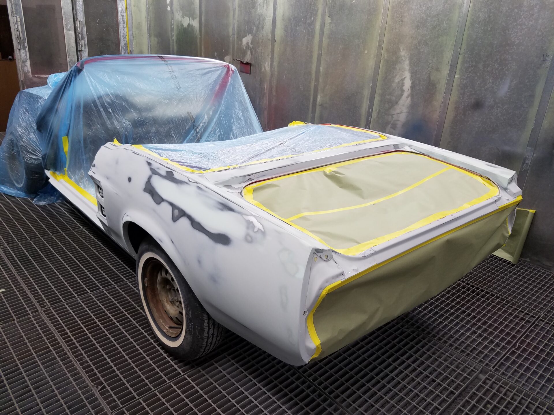 A white 1967 Ford Mustang Convertible covered in wraps