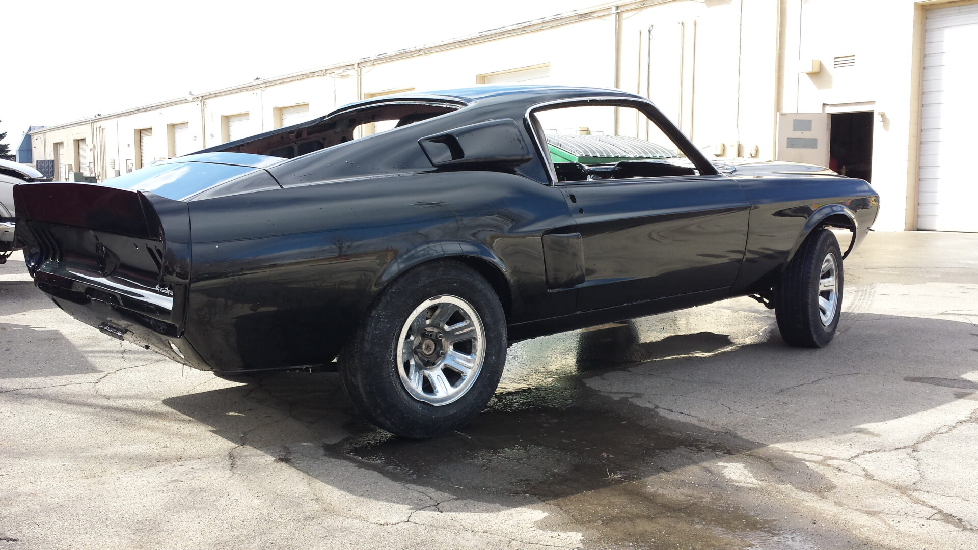 A black 1967 Ford Mustang Fastback