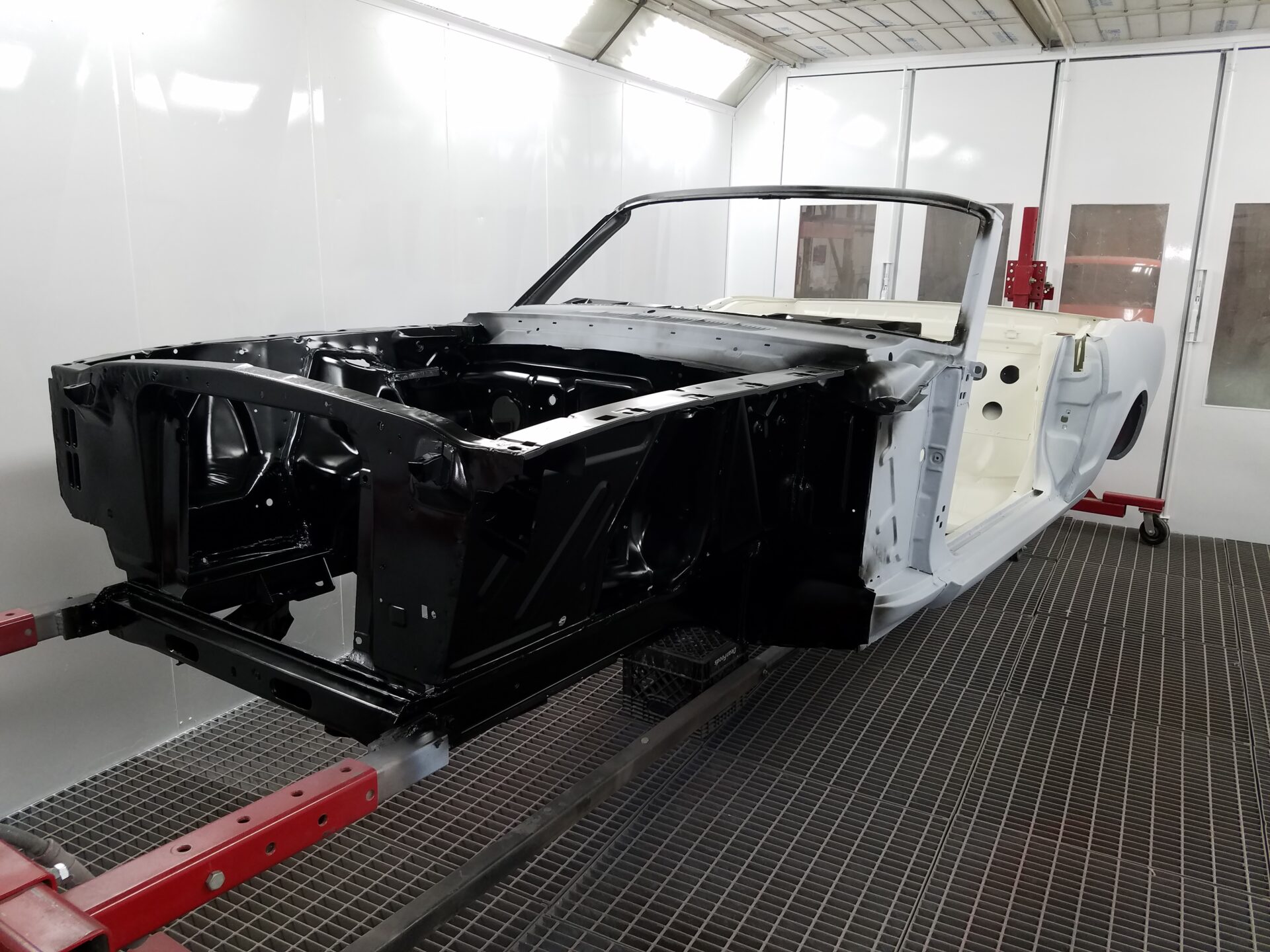 Black paint sprayed on the 1966 Ford Mustang Convertible frame