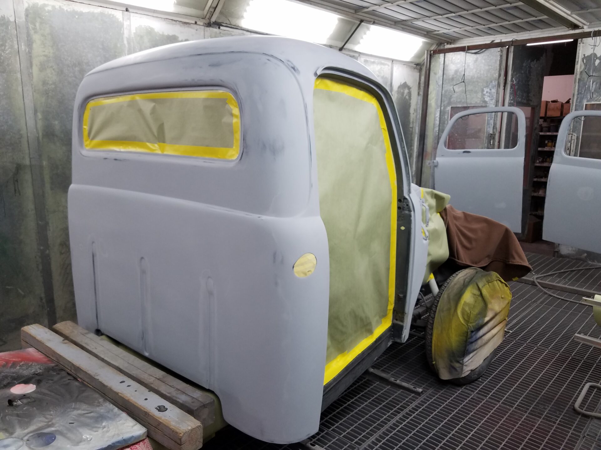 A 1952 Ford F100 model part undergoing a paint job