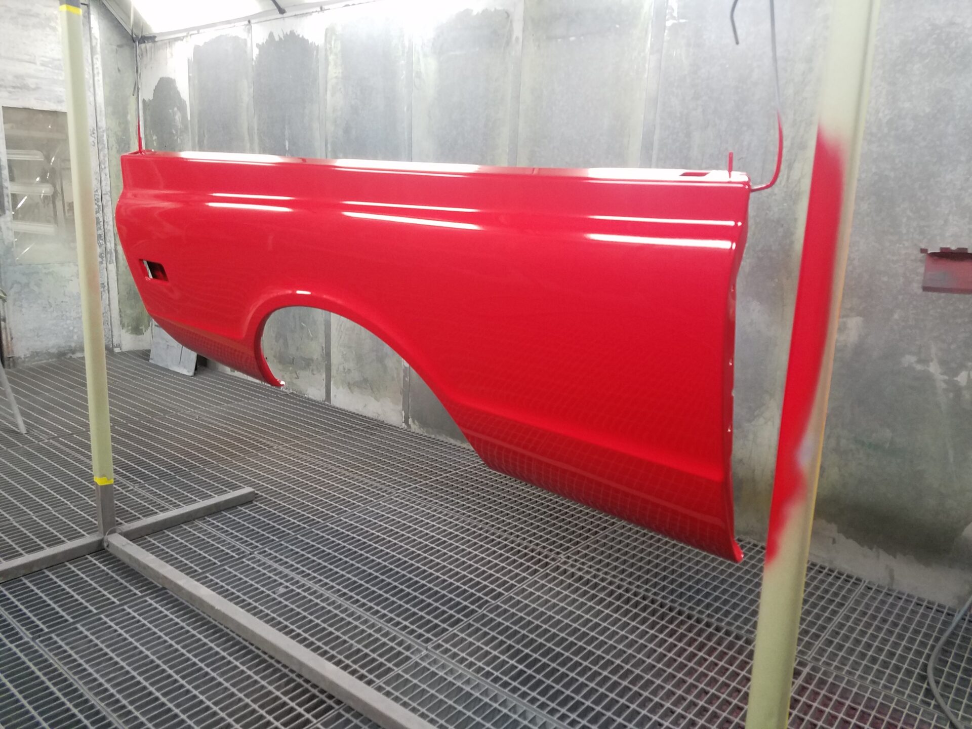 A newly painted red 1968 Chevy C10 part