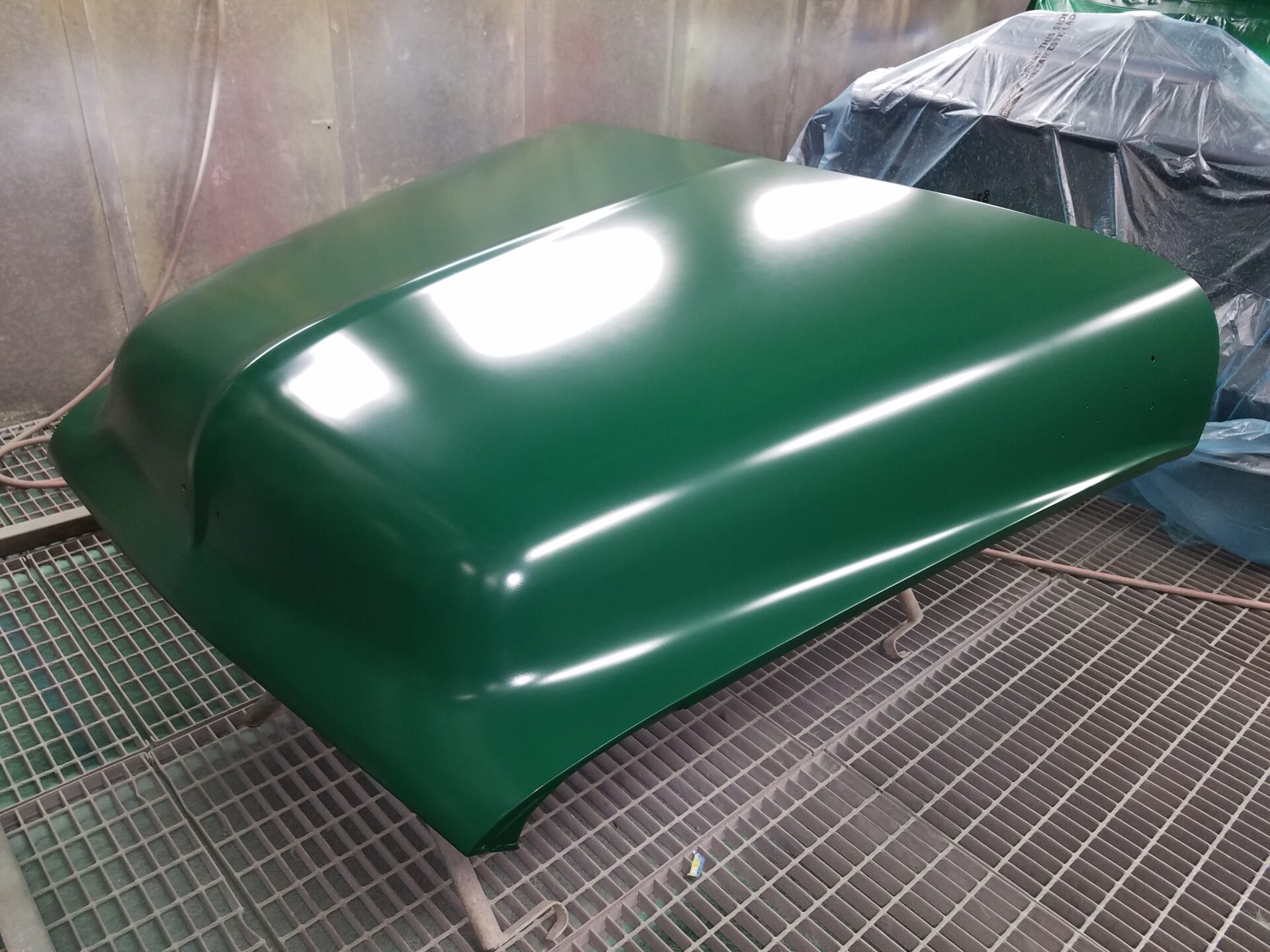 A newly painted green 1953 Ford F100 car part